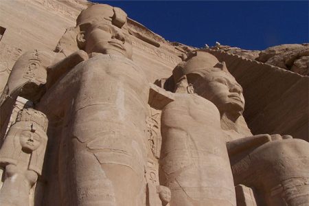 The intricately carved interior of the Great Temple of Abu Simbel, showing reliefs of Ramesses II and deities