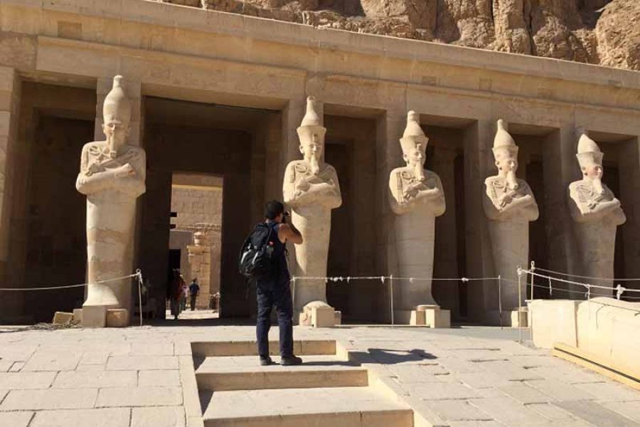 The striking multi-tiered terraces and elegant colonnades of the Temple of Hatshepsut, seamlessly carved into the dramatic, golden cliffs of Deir el-Bahari