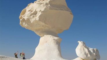 mushroom-shaped chalk rock formation standing prominently in the White Desert of Bahariya Oasis