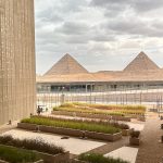 The Grand Egyptian Museum, a symbol of Egypt's cultural legacy, positioned in a frame that includes the Giza Pyramids